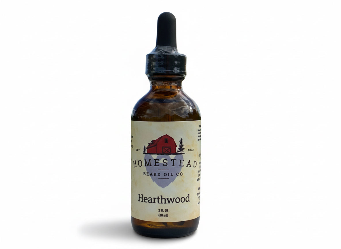 Bottle of Homestead Beard Oil Co. Hearthwood oil on a hay bale with a field and sky in the background