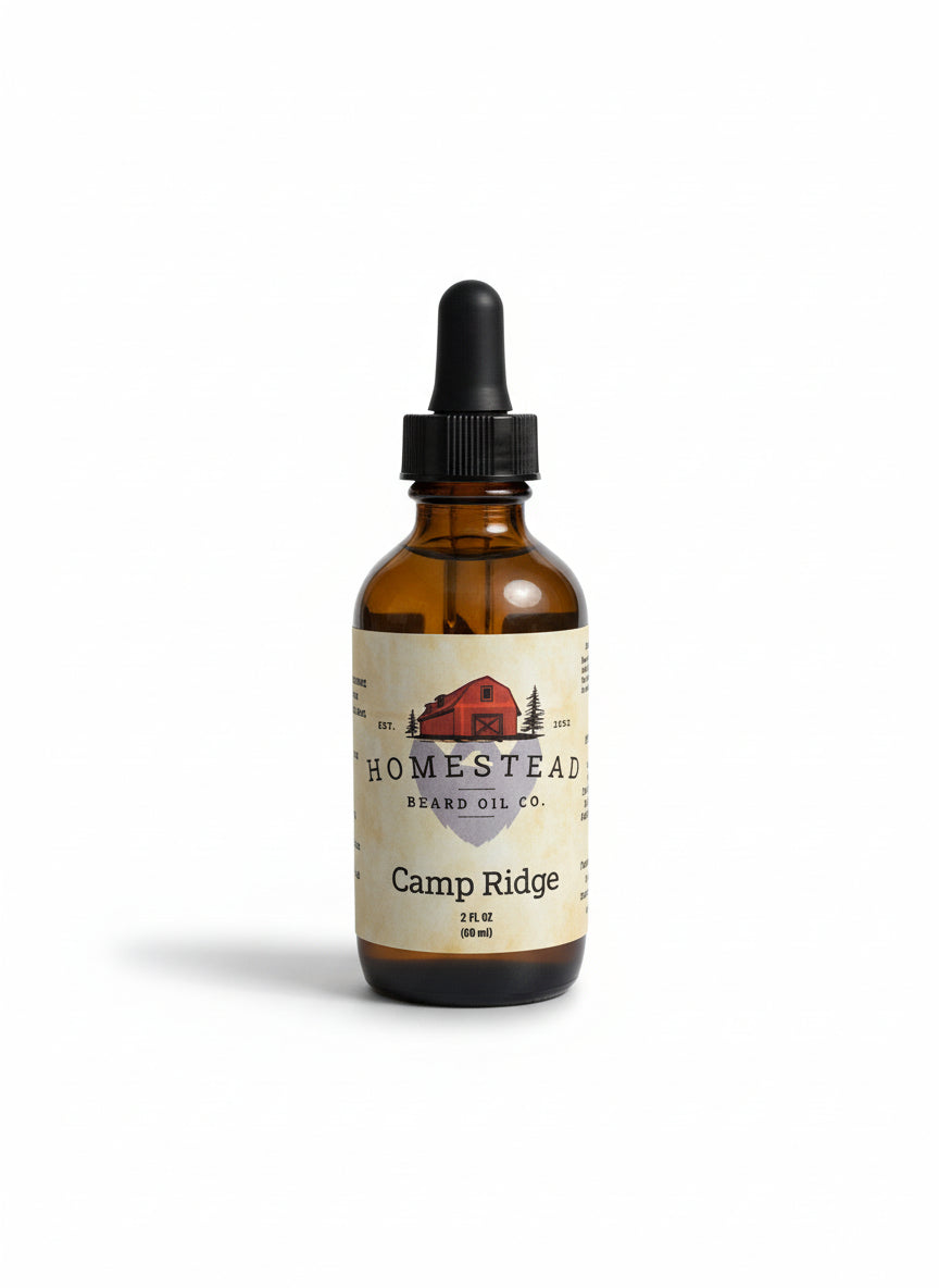 Bottle of Homestead Beard Oil Co. Camp Ridge on a hay bale with a field and trees in the background