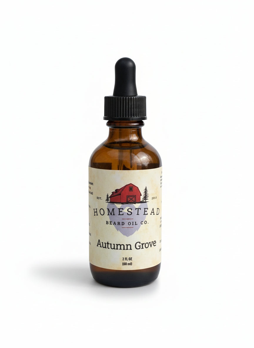 Bottle of Homestead Brand Oil Co. Autumn Grove oil with a blurred background of a field and water.