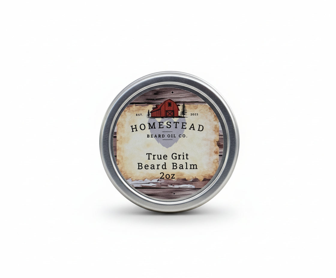 Homestead Beard Oil Co. True Grit Beard Balm container on a grassy field with a cloudy sky.