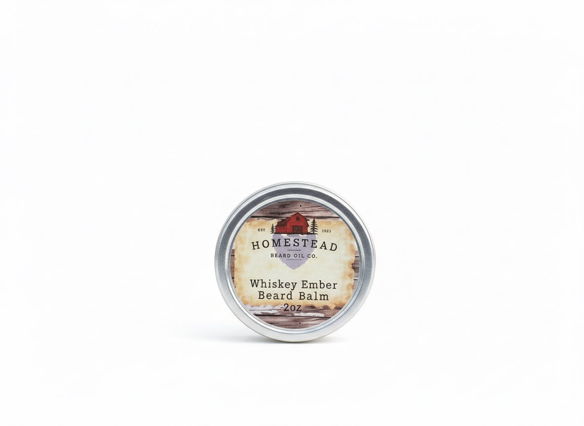 Homestead Herbs & Oil Co. Whiskey Ember Beard Balm container on a grassy field with a blue sky.
