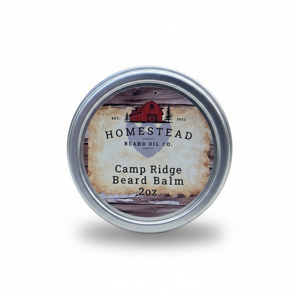 Homestead Beard Oil Co. Camp Ridge Beard Balm tin on a hay bale with a natural background