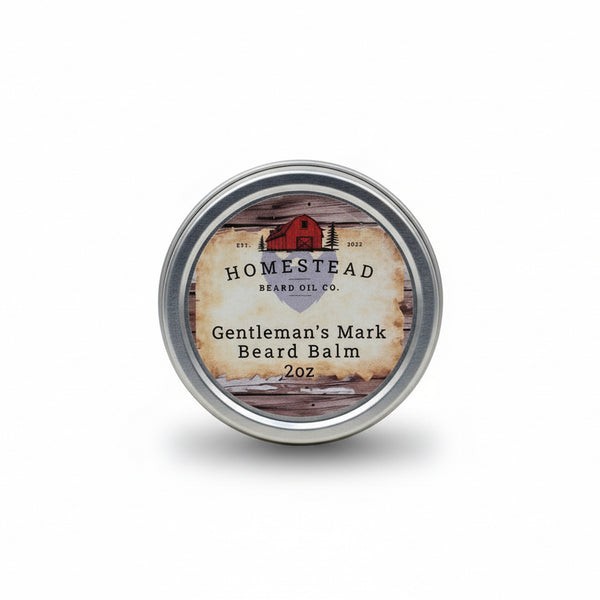 Homestead Beard Oil Co. Gentleman's Mark Beard Balm container on a natural background with a field and sky in the background.