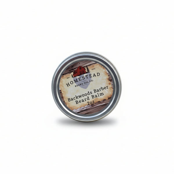 Homestead Beard Oil Co. Backwoods Barber Beard Balm container on a hay bale with a scenic background