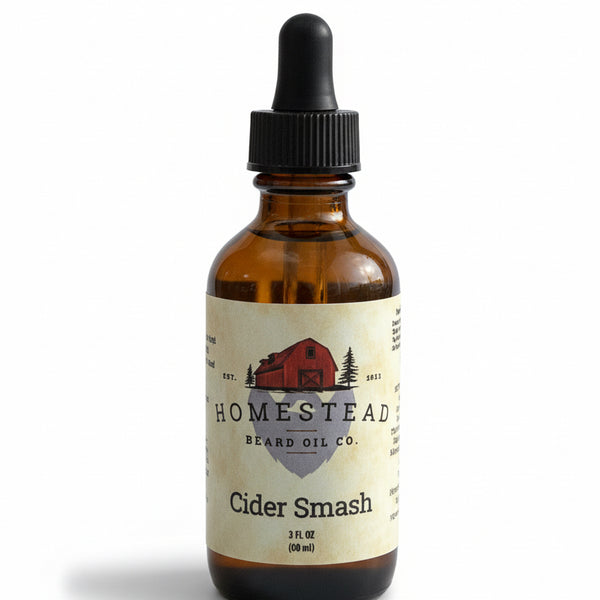 Bottle of Homestead Beard Oil Co. Cider Smash on a grassy field with a blue sky.