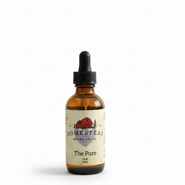 Bottle of Homestead Beard Oil Co. on a hay bale with a field and blue sky in the background