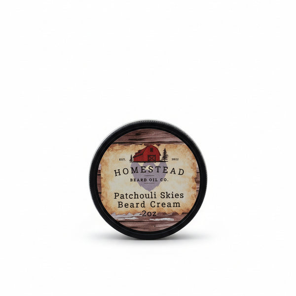 Homestead Brand Oil Co. patchouli skies beard cream container on a hay bale with a blue sky background