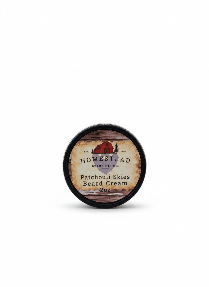 Homestead Brand Oil Co. patchouli skies beard cream container on a hay bale with a blue sky background