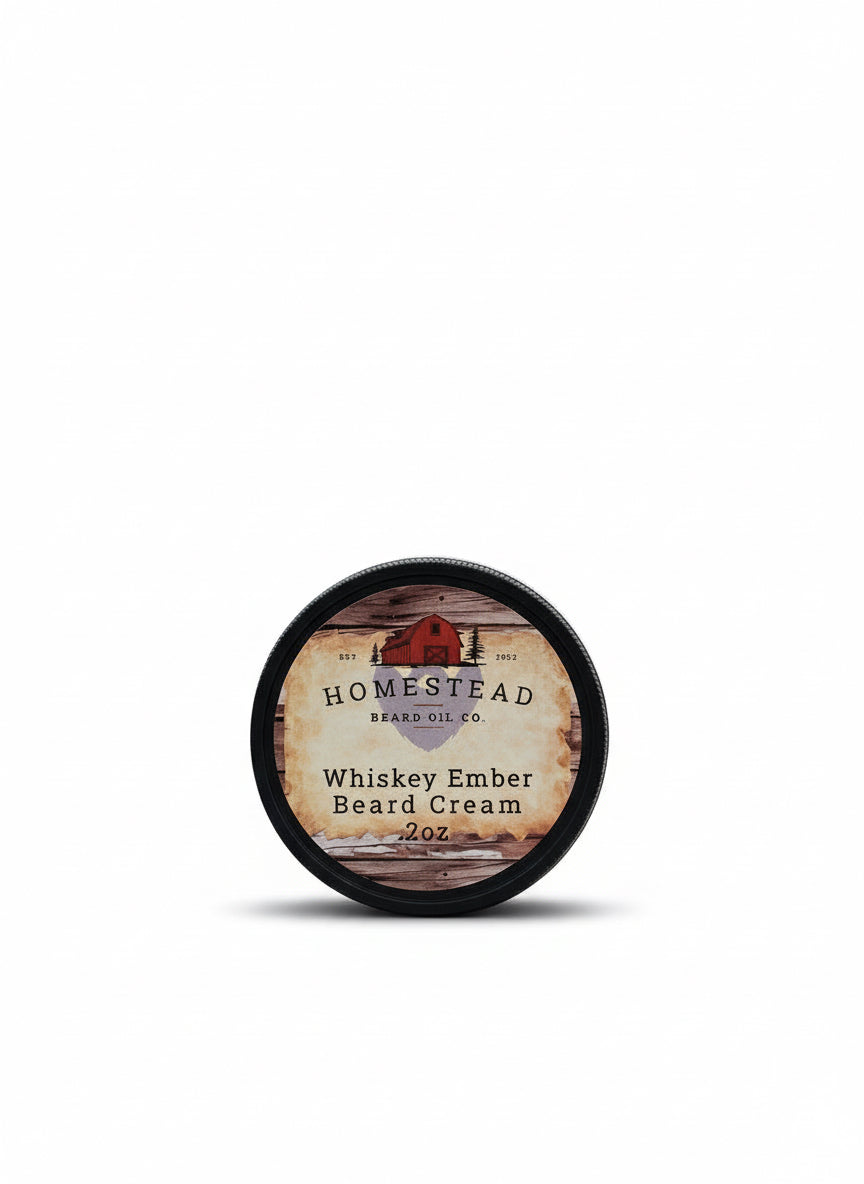 Homestead Beard Oil Co. Whiskey Ember Beard Cream container on a grassy field with a barn in the background.