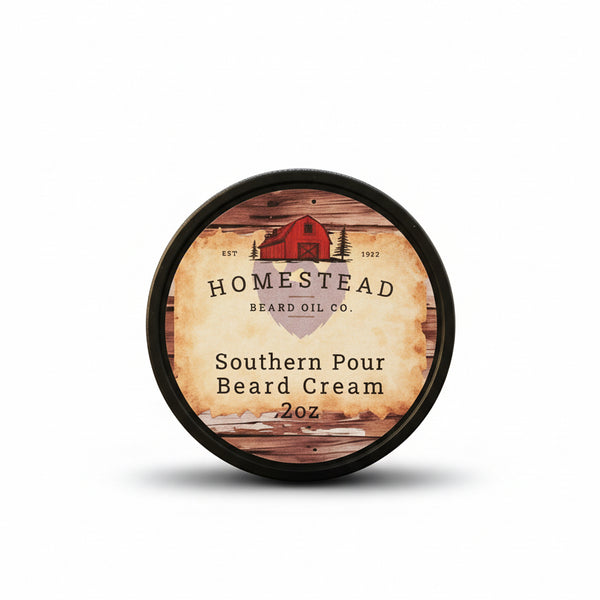 Homestead Beard Oil Co. Southern Pour Beard Cream container on a straw background with a blurred natural landscape.