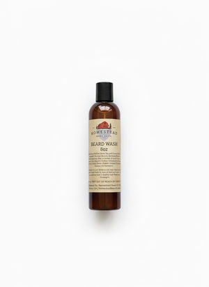 Bottle of Homestead Beard Oil Co. beard wash on a rugged surface